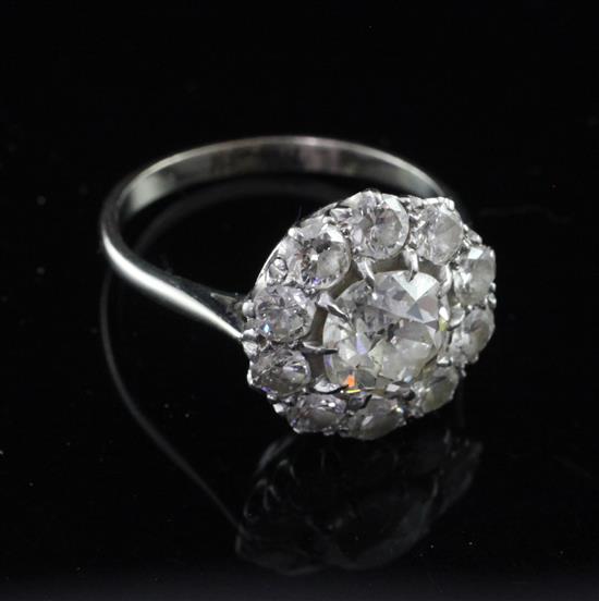 An early 20th century white gold and diamond cluster flower head ring, size O.